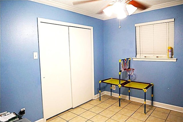 recreation room with a ceiling fan, light tile patterned flooring, crown molding, and baseboards