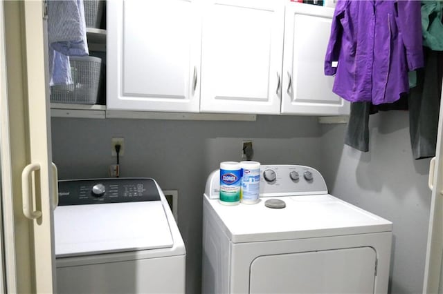 laundry area with cabinet space and separate washer and dryer