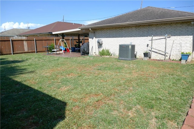 exterior space with brick siding, a yard, and central AC unit