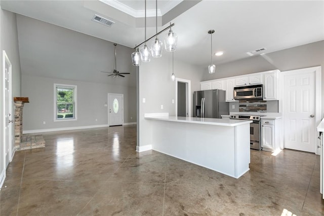 kitchen with tile patterned floors, ceiling fan, stainless steel appliances, pendant lighting, and white cabinets