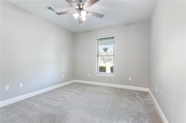 unfurnished room with ceiling fan and light colored carpet