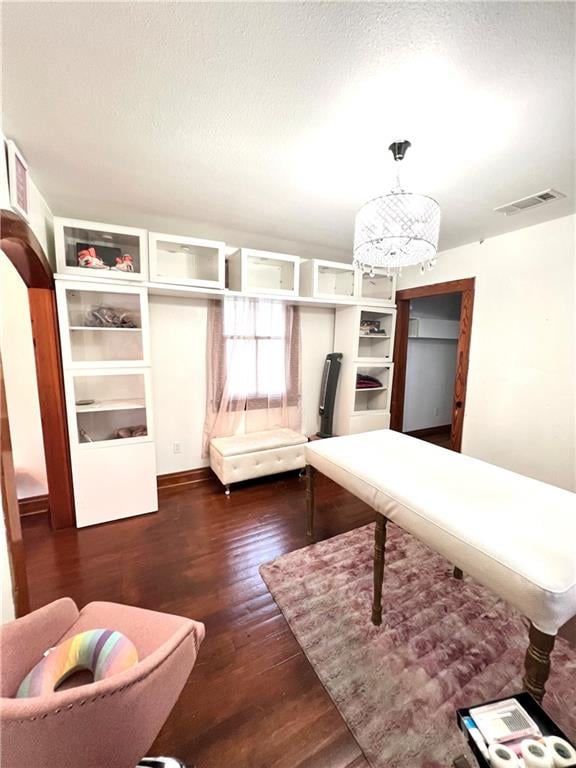 unfurnished bedroom featuring dark hardwood / wood-style flooring and a textured ceiling