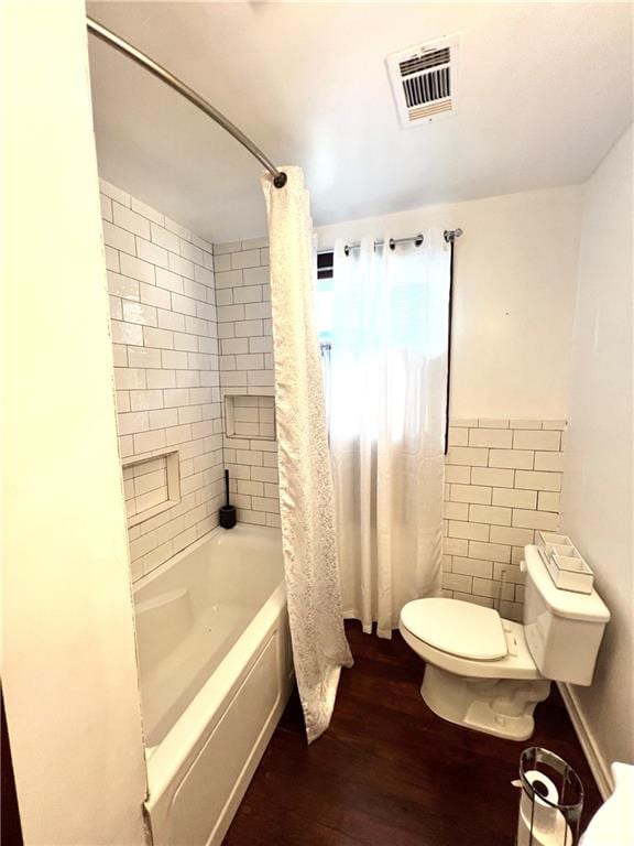 bathroom featuring shower / tub combo, hardwood / wood-style flooring, and toilet