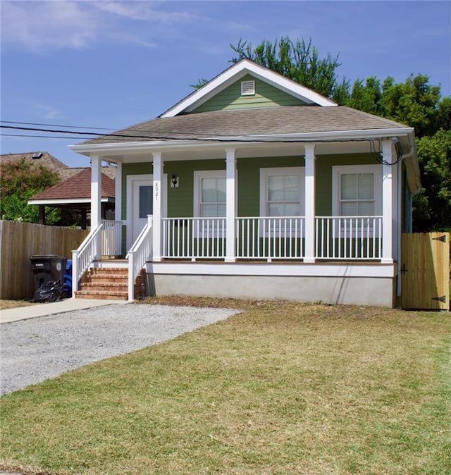 bungalow-style house with a porch and a front lawn