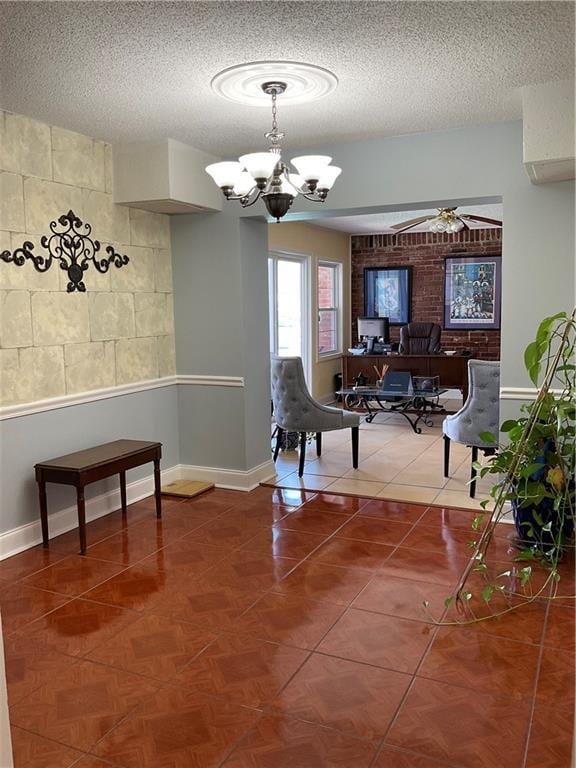 interior space with an inviting chandelier, tile patterned flooring, baseboards, and a textured ceiling