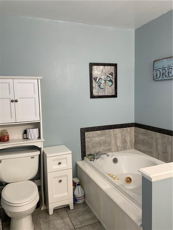 bathroom featuring a jetted tub and toilet