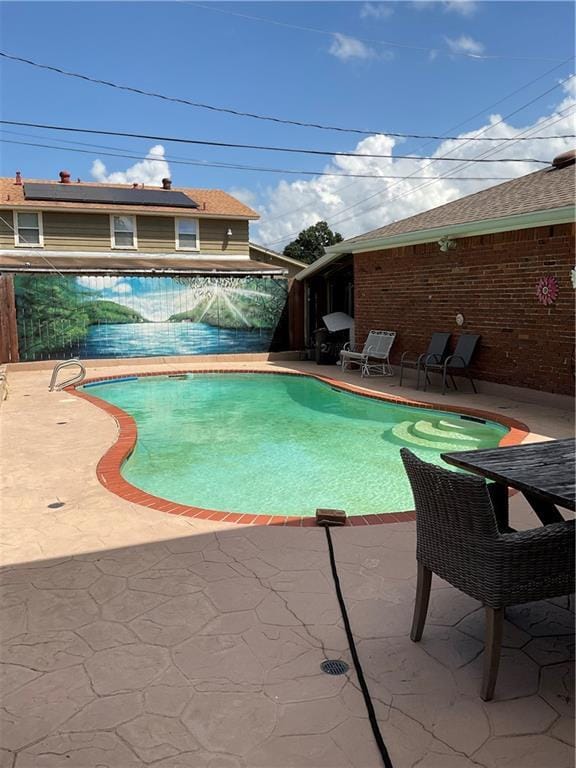 view of swimming pool with a patio area and a fenced in pool