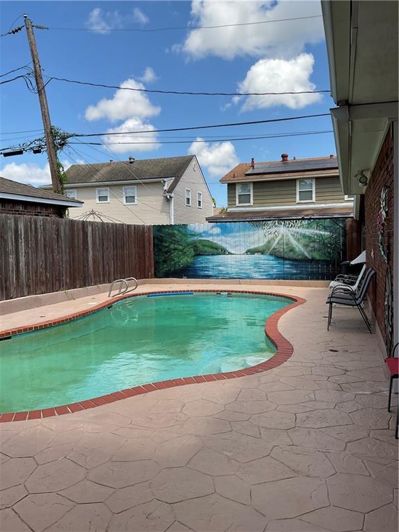 view of swimming pool with a patio area, a fenced backyard, and a fenced in pool