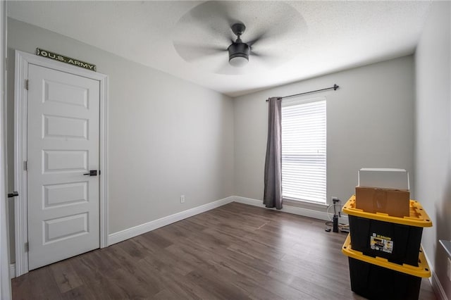 unfurnished room with ceiling fan, plenty of natural light, and wood-type flooring