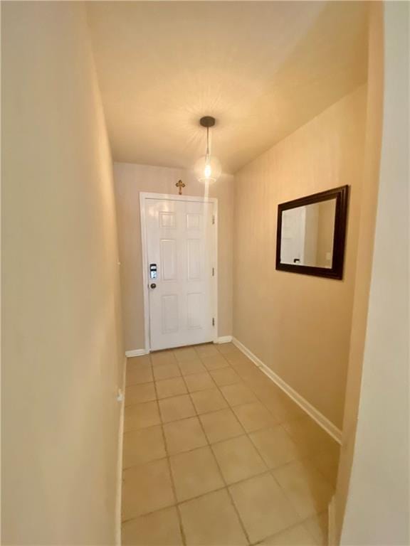 entryway with tile patterned flooring and baseboards