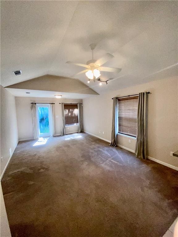 unfurnished living room with lofted ceiling, ceiling fan, visible vents, and carpet flooring