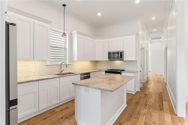 kitchen featuring sink, decorative backsplash, light wood-type flooring, and stainless steel appliances