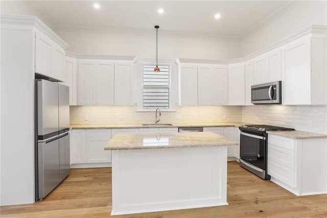 kitchen with light hardwood / wood-style floors, sink, stainless steel appliances, and decorative backsplash