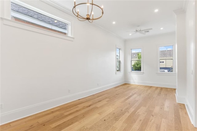 empty room with light hardwood / wood-style floors, ceiling fan with notable chandelier, and crown molding