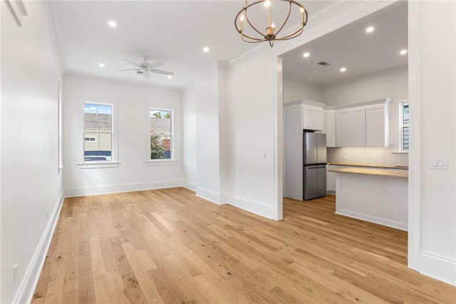 interior space featuring ceiling fan with notable chandelier, crown molding, and light hardwood / wood-style flooring