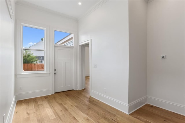 interior space featuring crown molding and light hardwood / wood-style floors