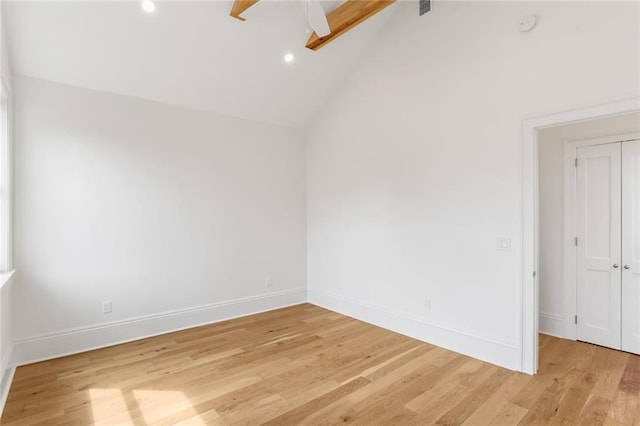 spare room featuring ceiling fan, light hardwood / wood-style flooring, and lofted ceiling