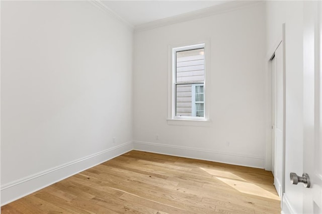 unfurnished room featuring crown molding and light hardwood / wood-style floors