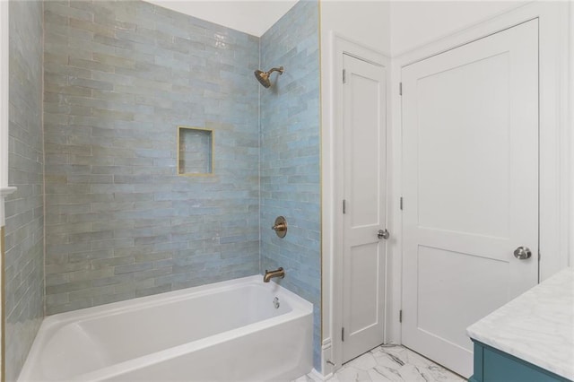 bathroom featuring tiled shower / bath combo, tile patterned flooring, and vanity