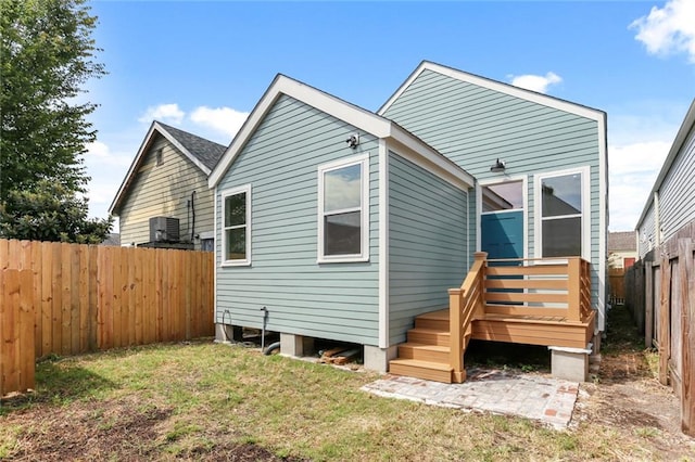 rear view of house with central AC unit