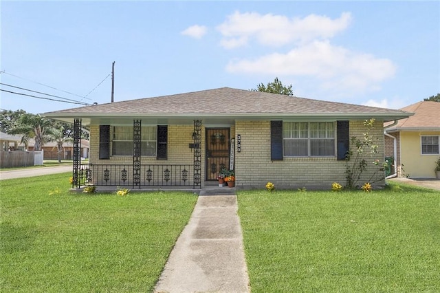 view of front of house with a front yard and covered porch