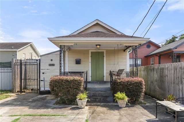 2546 Elder St, New Orleans, LA 70122 - shotgun-style home featuring a porch and fence