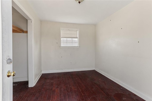 unfurnished room with dark hardwood / wood-style flooring