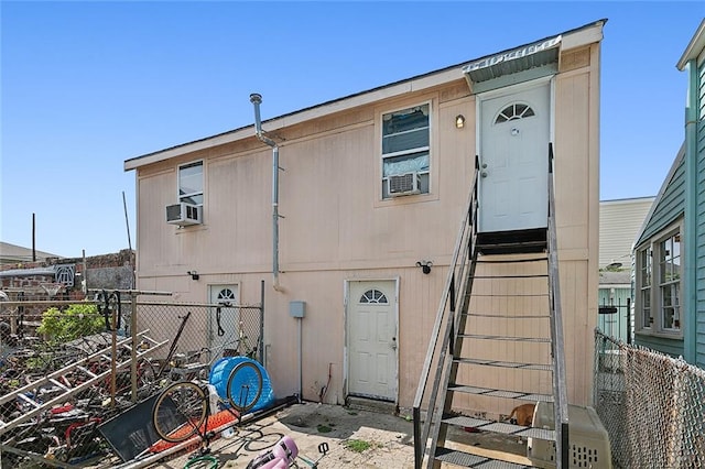 rear view of house featuring cooling unit