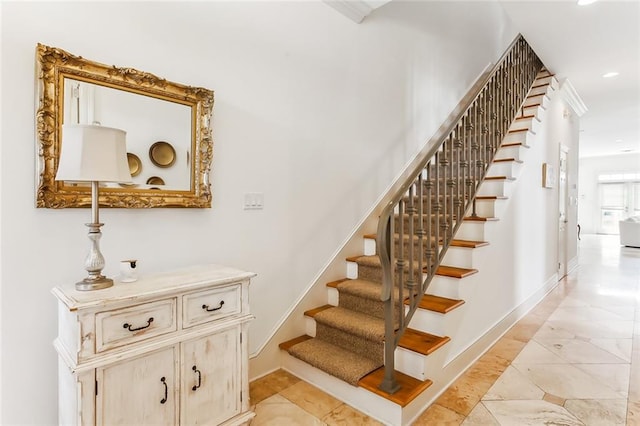 stairway with tile patterned floors