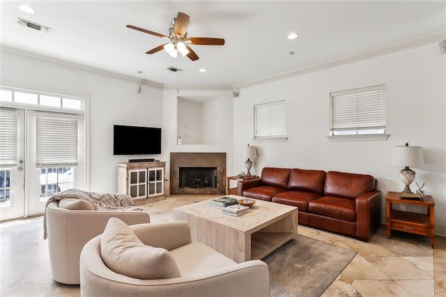 living room featuring ceiling fan, light tile patterned floors, and ornamental molding