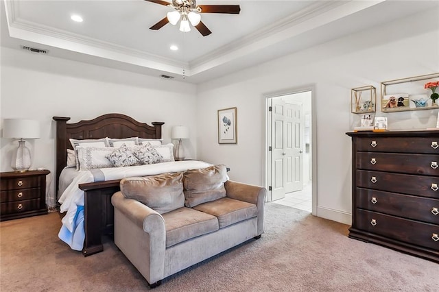 carpeted bedroom with ceiling fan and a raised ceiling