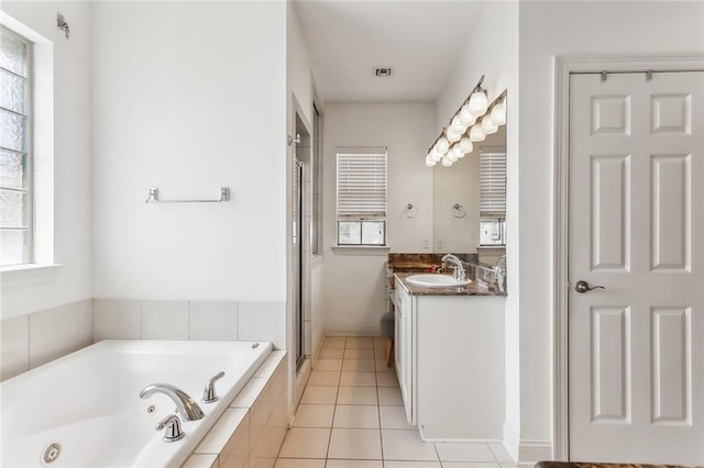 bathroom with tile patterned flooring, vanity, and independent shower and bath