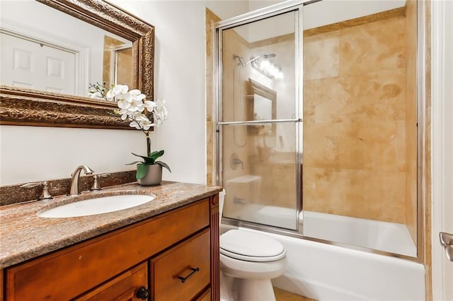 full bathroom with toilet, vanity, and enclosed tub / shower combo