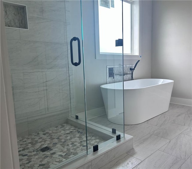 bathroom featuring shower with separate bathtub