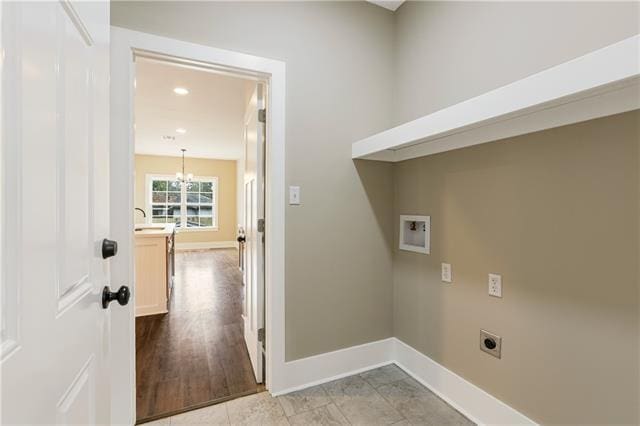 washroom featuring light tile patterned floors, a notable chandelier, electric dryer hookup, and washer hookup