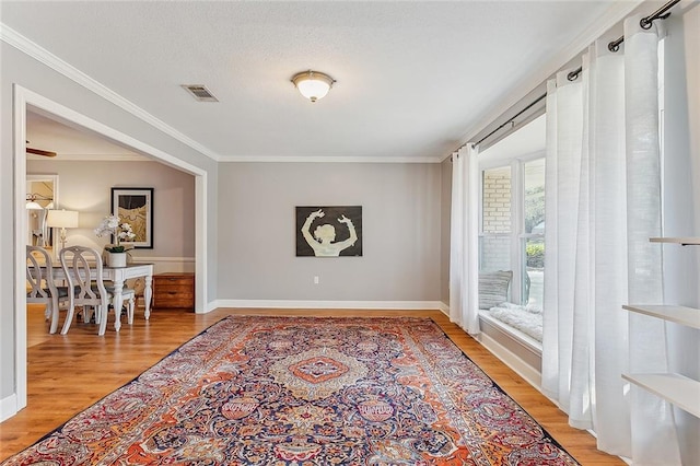 interior space featuring light hardwood / wood-style floors and ornamental molding