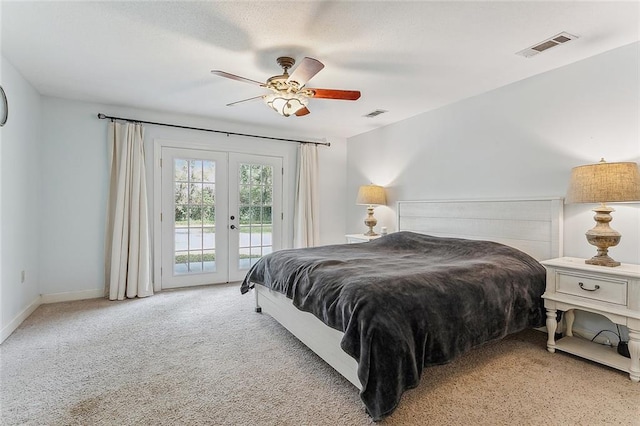 bedroom with light colored carpet, ceiling fan, french doors, and access to exterior