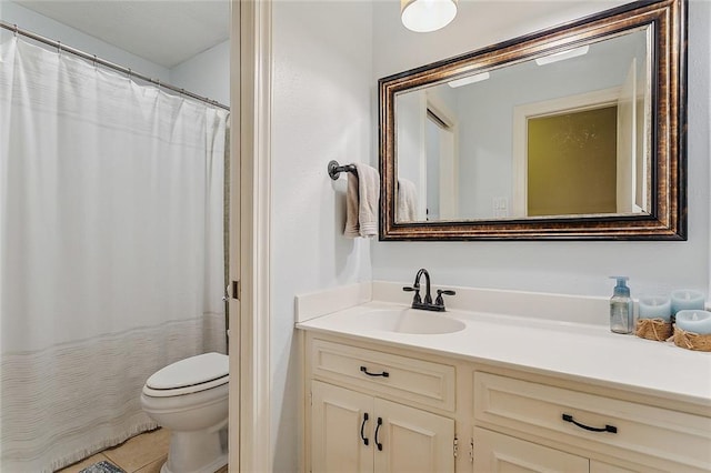 bathroom with curtained shower, vanity, toilet, and tile patterned floors