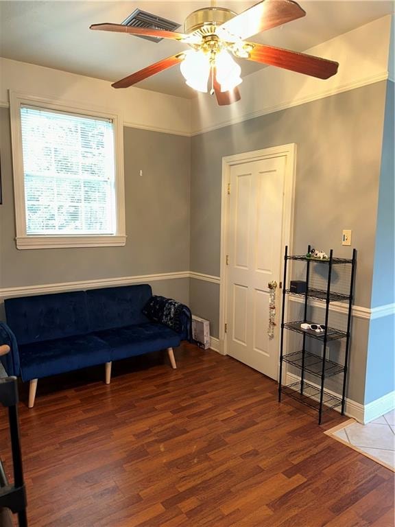 living area with ceiling fan and hardwood / wood-style floors