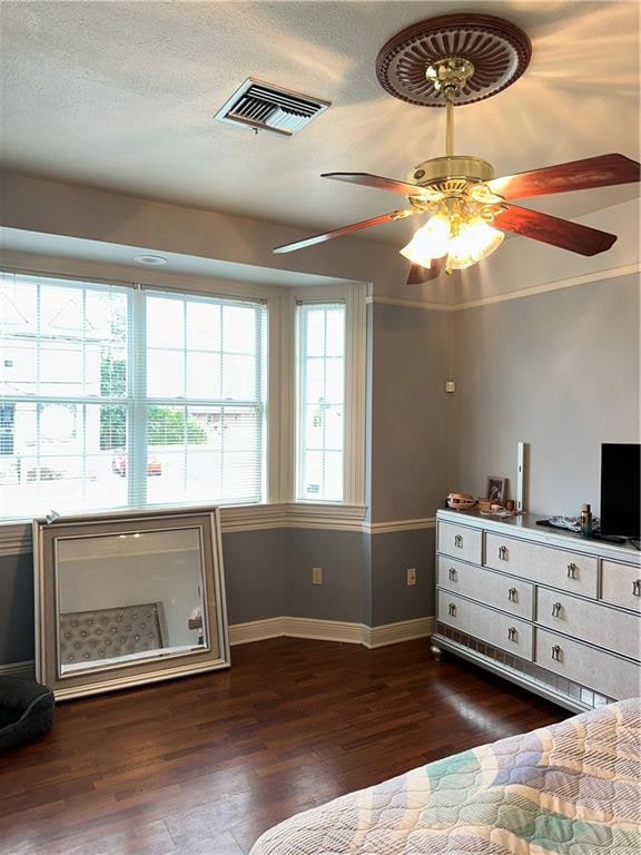 bedroom with ceiling fan and dark hardwood / wood-style flooring