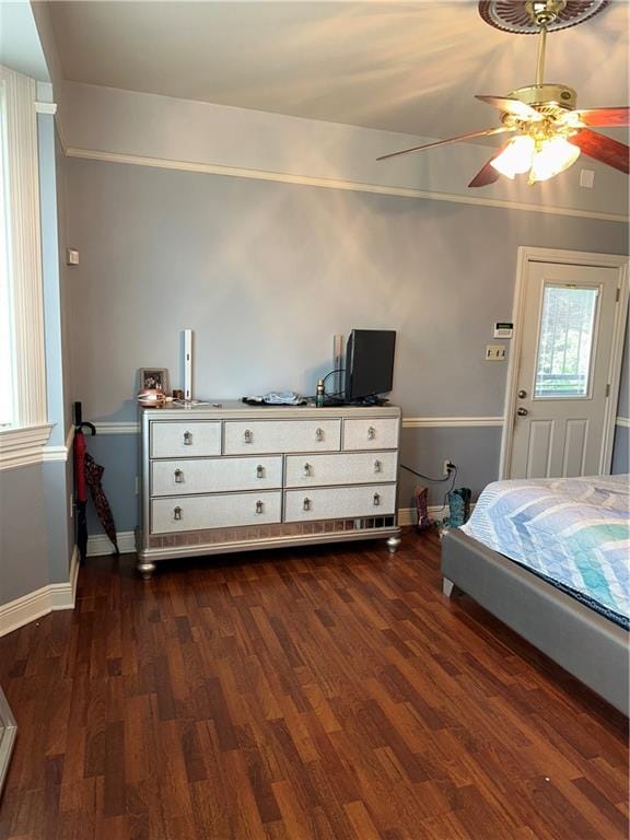 bedroom with ceiling fan and dark hardwood / wood-style flooring