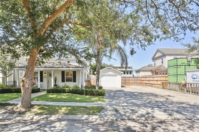 view of front of home with a garage, a front lawn, and an outdoor structure