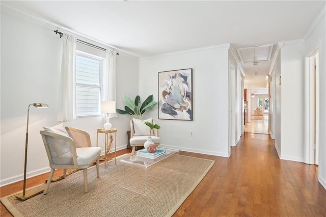 living area featuring wood-type flooring and ornamental molding