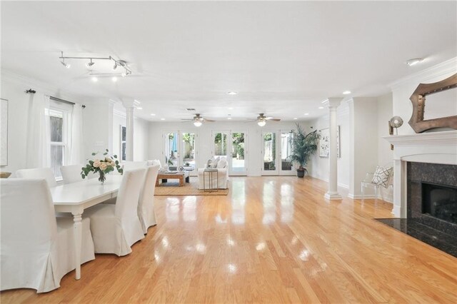 dining room with ceiling fan, french doors, ornamental molding, and light wood-type flooring