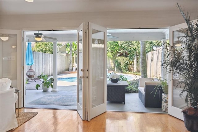 doorway featuring hardwood / wood-style floors and ceiling fan