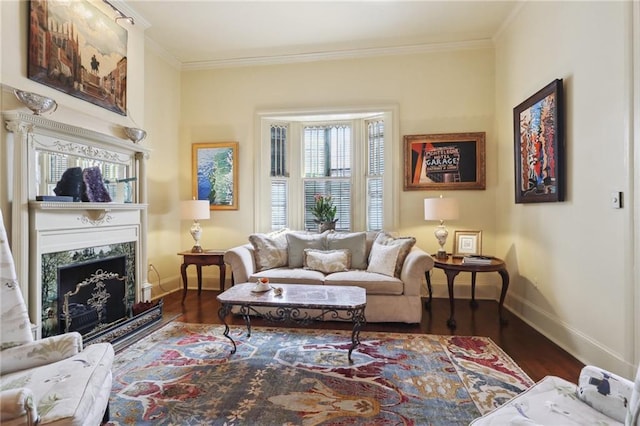 living room with dark wood-type flooring, ornamental molding, and a premium fireplace