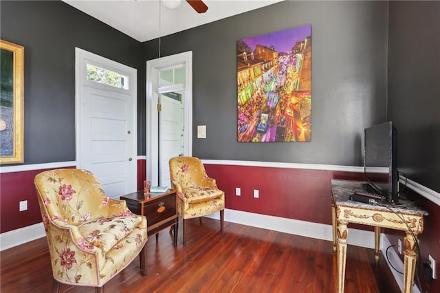 sitting room featuring ceiling fan and dark hardwood / wood-style floors