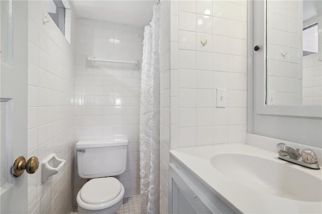 bathroom featuring tile walls, vanity, walk in shower, and toilet