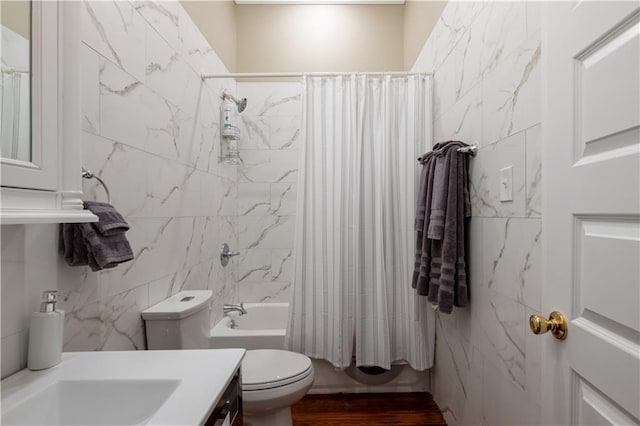 full bathroom with shower / bath combination with curtain, toilet, tile walls, and vanity