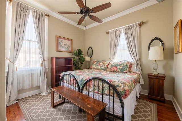 bedroom with ceiling fan, wood-type flooring, and crown molding